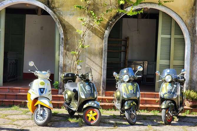 Vespa riding past rice fields near Hoi An