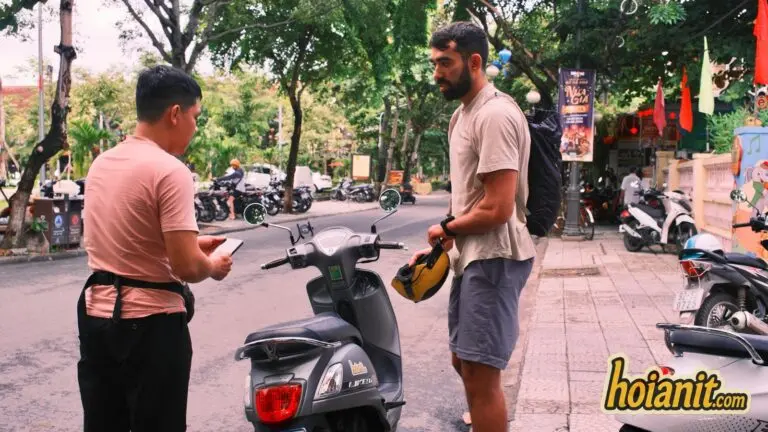 Staff handing over a rental scooter at the hotel