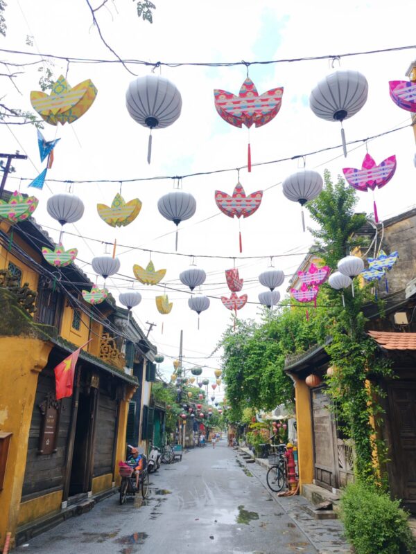 Hoi An old town street strung with silk lanterns and adidas logo lanterns