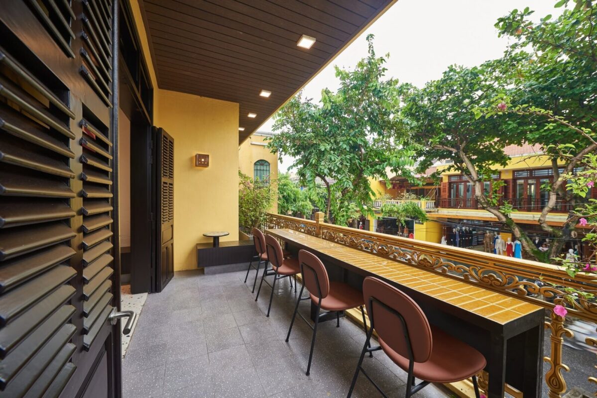 Starbucks Hoi An balcony overlooking trees and yellow houses