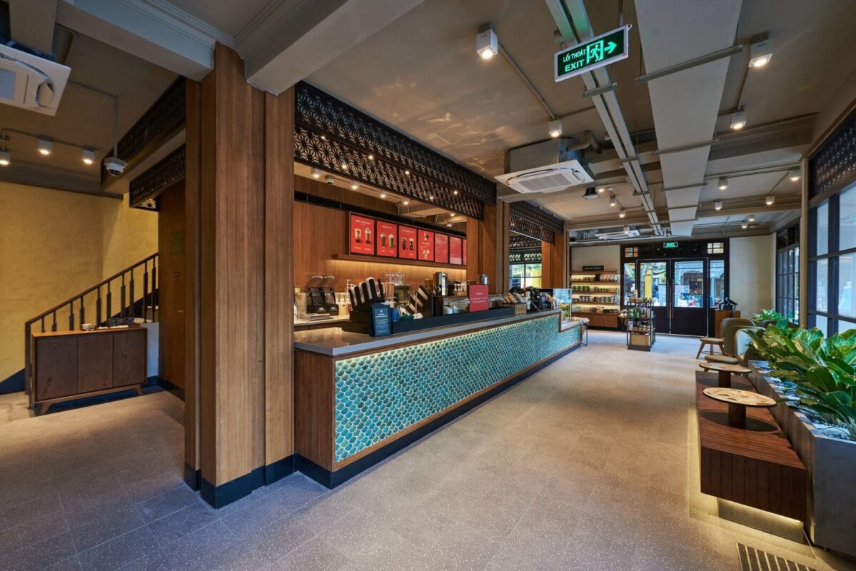 Patterned-tile bar counter and wooden pillars inside Starbucks Hoi An